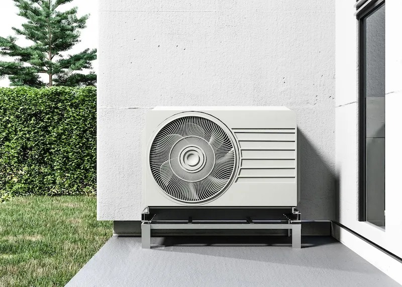 Close-up of an air source heat pump outside a home