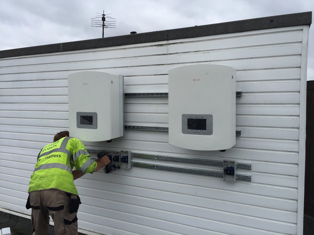 A Brightspark employee install PV inverters